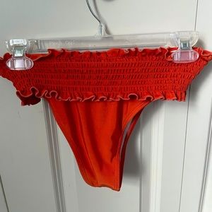 Orange/Red bathing suit bottoms.